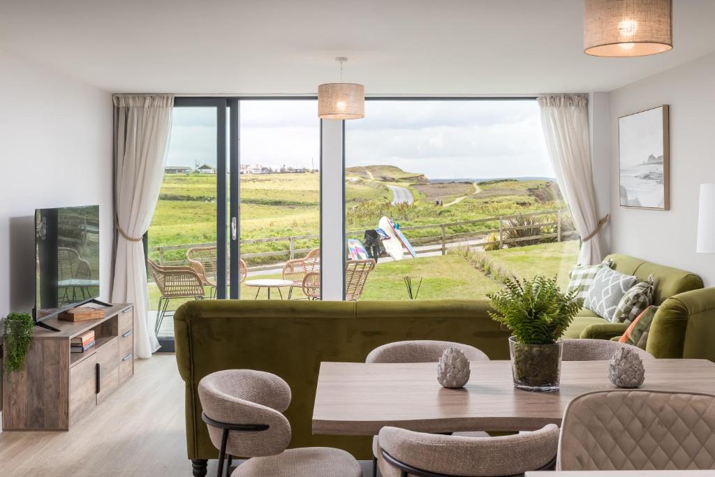 a living room with a couch and a table at Luxury Sea View Apartments in Bude with Garden, Sleep 6 in Bude