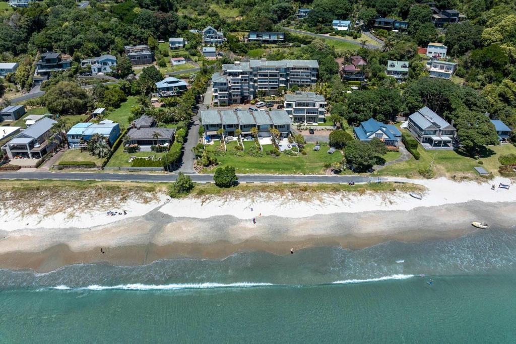 an aerial view of a beach with condos and the ocean at The Sands - Apartment 12 - Stay Waiheke in Onetangi