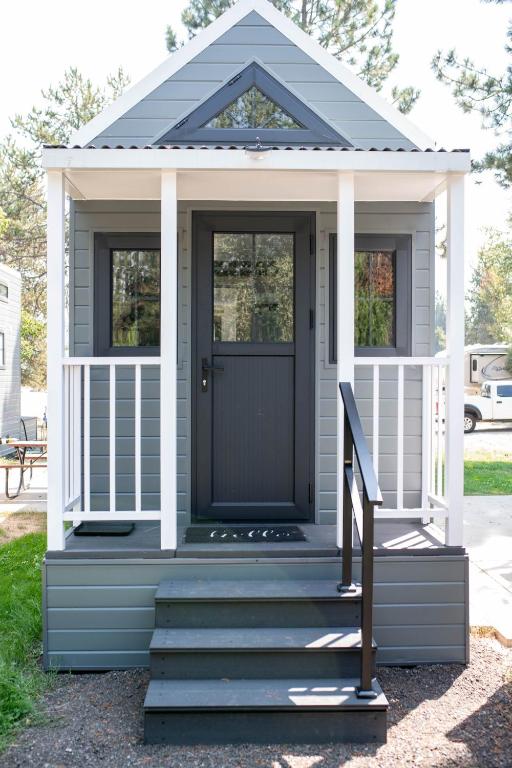 a gazebo with a black door and stairs at Gold Mine Lofts in Idaho City