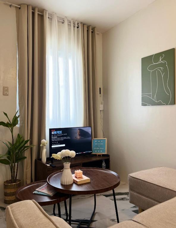 a living room with a coffee table and a television at Solara Villa, Gensan in General Santos