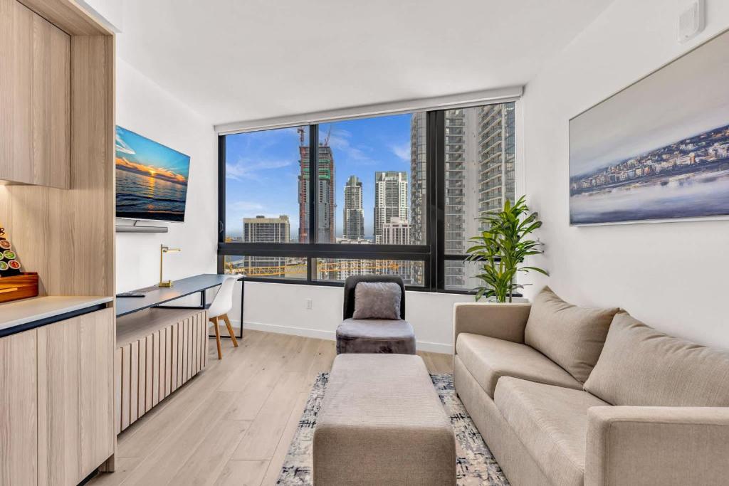 a living room with a couch and a large window at Beautiful Miami Apt Pool & Beach for 3 Guests in Miami