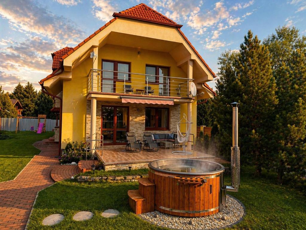 a large wooden tub in the yard of a house at Bikehouse in Veľká Lomnica