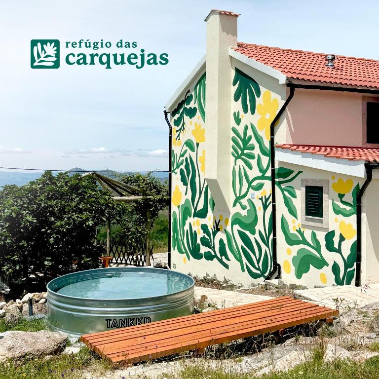 a house with a painting on the side of it at Refúgio das Carquejas in Mondim de Basto
