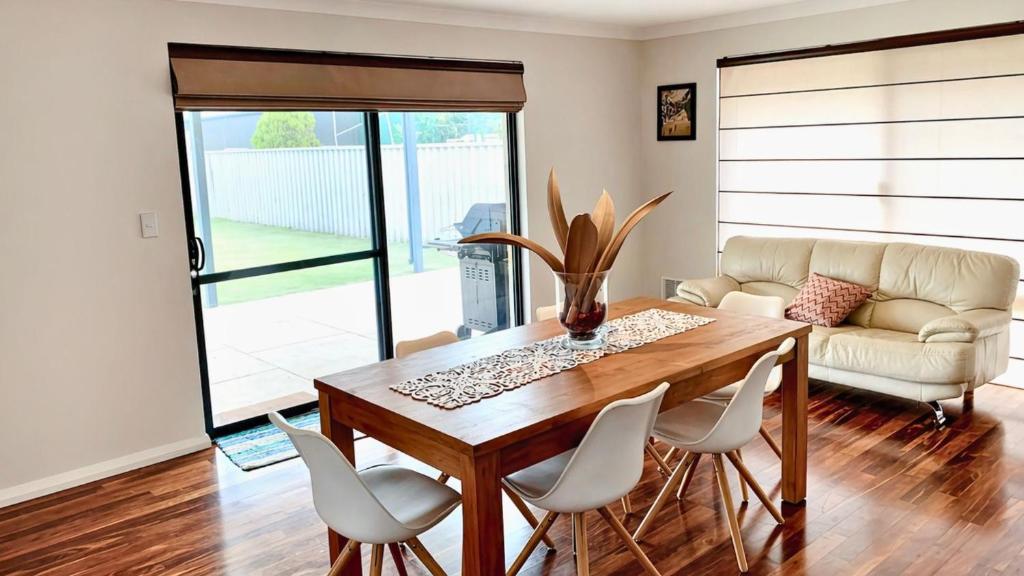 a living room with a table and chairs and a couch at Wagon Holiday Home in Broadwater