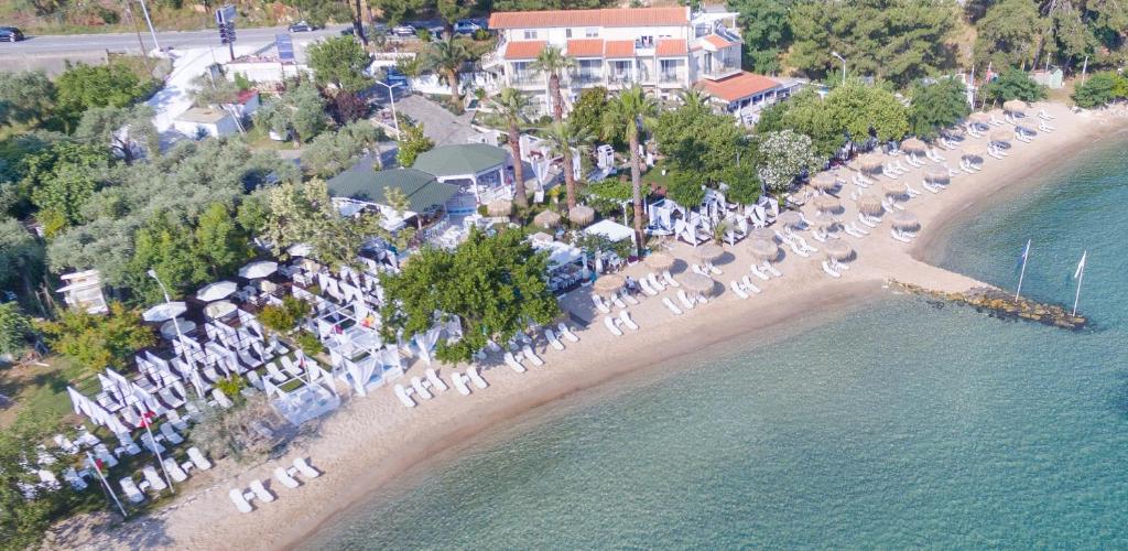 an aerial view of a beach with tables and chairs at Tarsanas Studios in Limenas