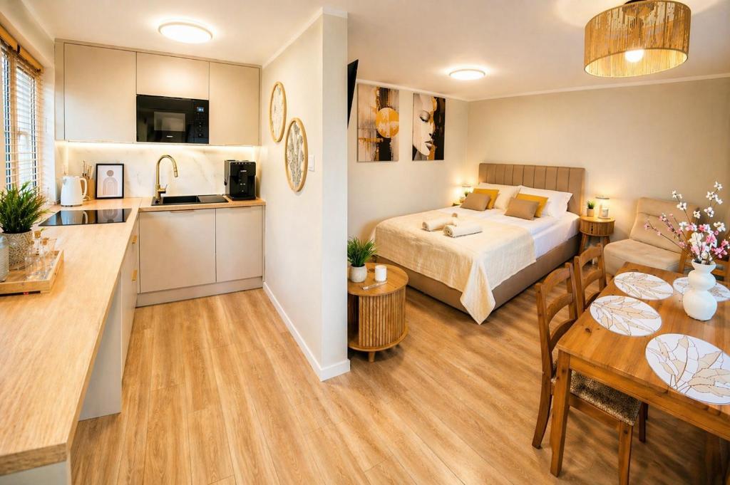a kitchen and a bedroom with a bed in a room at Lake House Mierzyn in Mierzyn