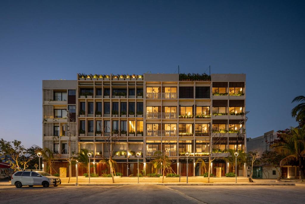 a large building with a car parked in front of it at Donceles Plaza in Cancún