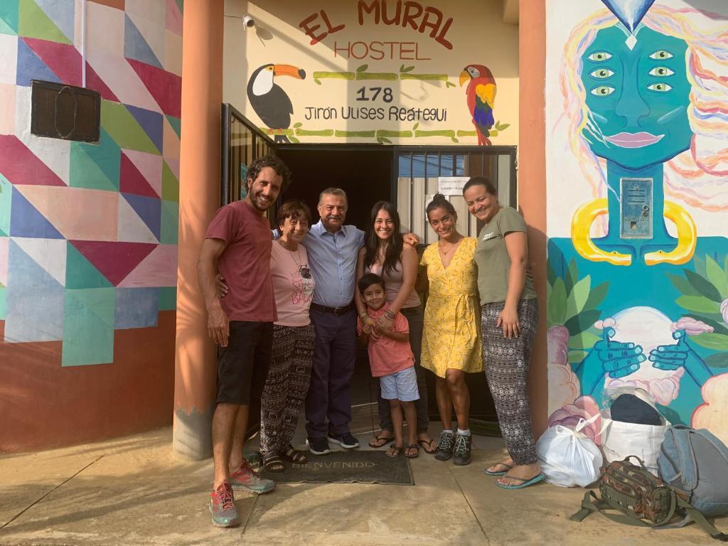 a group of people standing in front of a building at El Mural Backpackers in Tarapoto