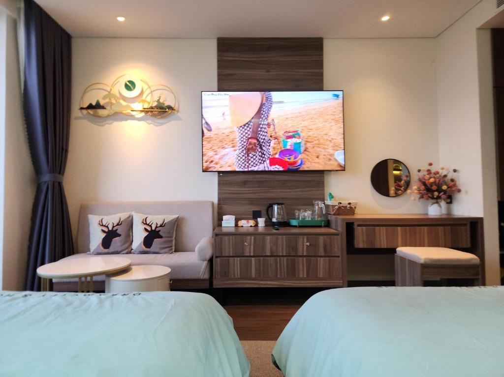 a hotel room with a flat screen tv on the wall at Yana Apec Phu Yen in Tuy Hoa