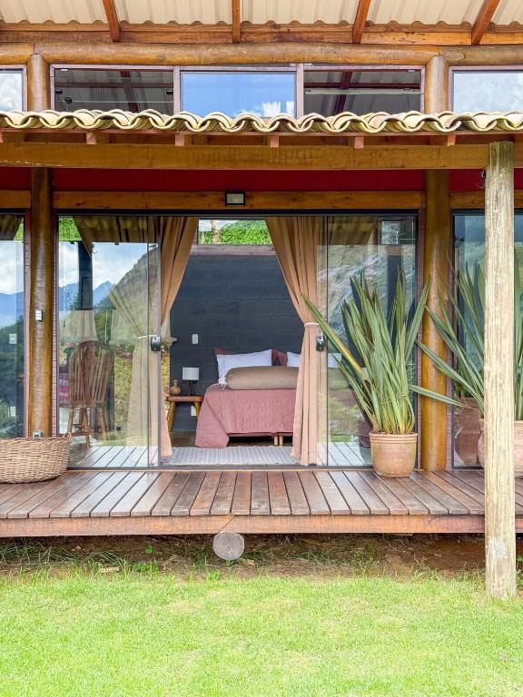 a wooden deck with a bedroom inside of a house at Loft Pitangueira in Petrópolis