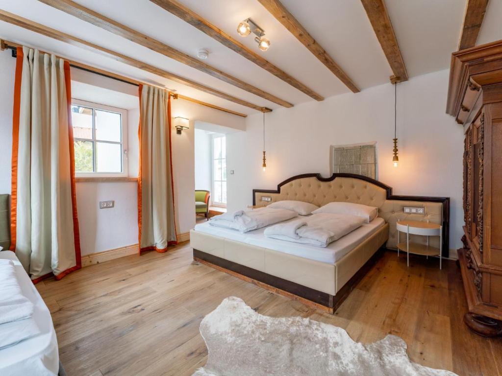 a bedroom with a bed and a table in a room at Biber Art Apartment 2 Small in Biberwier