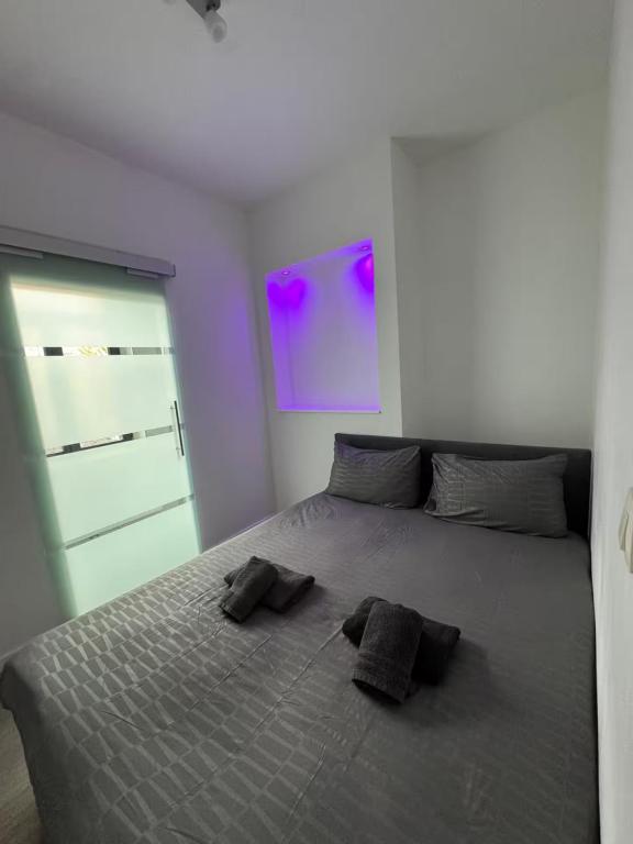 a bedroom with a bed with two pillows on it at Stylish 1BR Apartment Close to City Center Liège in Liège