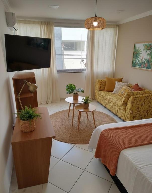 a living room with a bed and a couch at Hotel Copacabana Stay in Serra
