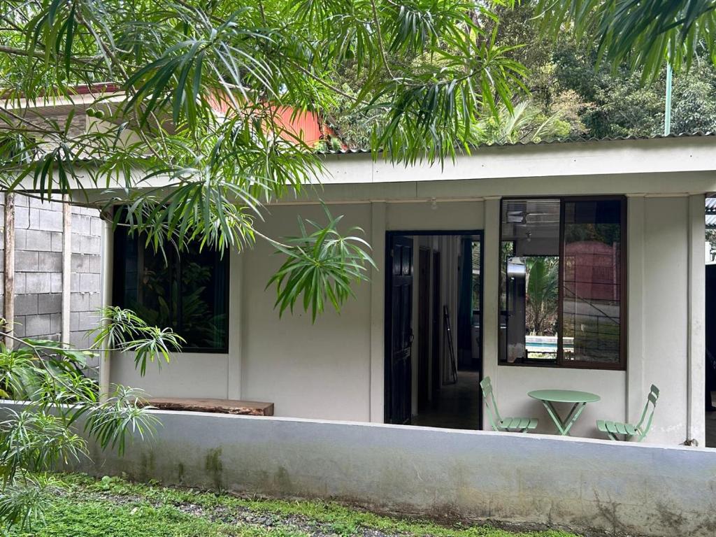 a house with a glass door and a table at Casa Mate y Mar in Punta Leona