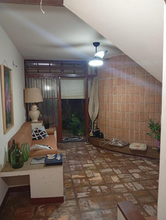 a living room with a couch and a table at Casa Duque in Ribeirão Preto