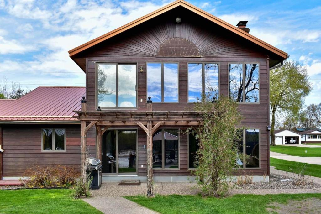 a house with large windows on the front of it at FC River Retreat in Wilson