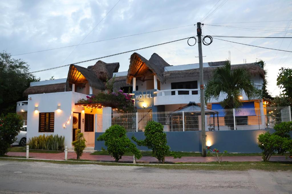 a white house with a shark head on the roof at Hotel Maria Maria in Bacalar