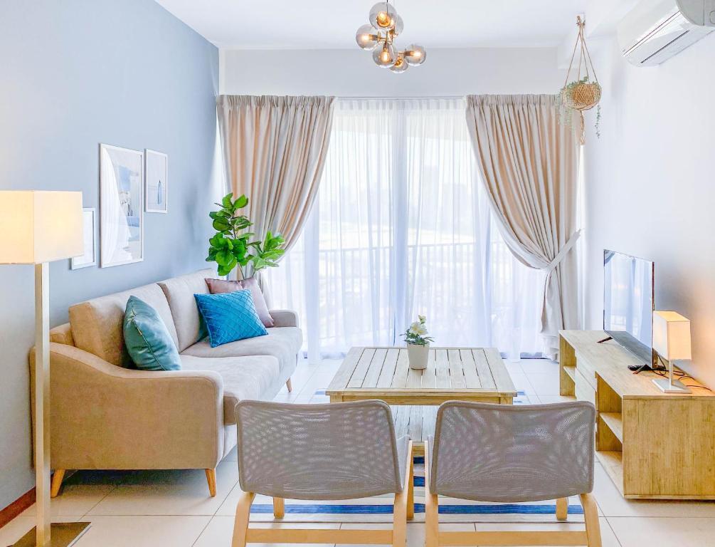 a living room with a couch and a table at The Landmark By Katana Penang in Tanjong Tokong
