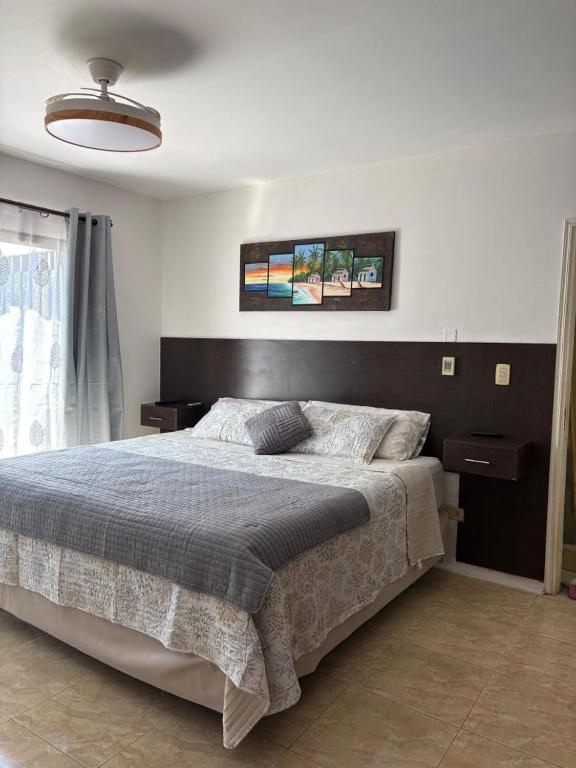 a bedroom with a large bed in a room at La Delfina in Chacras de Coria