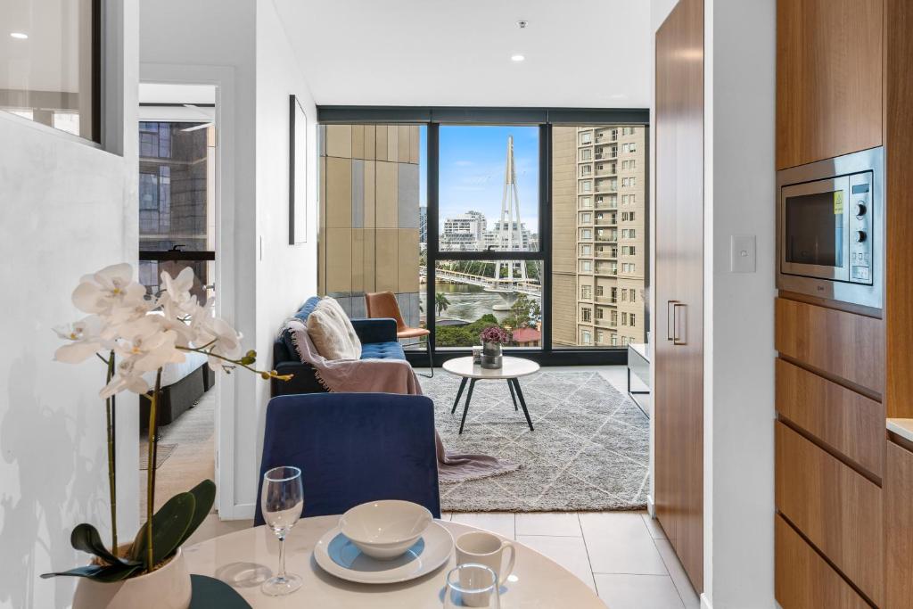 a living room with a view of a building at CBD RiverView 2Bed Apt Kingbed at Tallest building in Brisbane