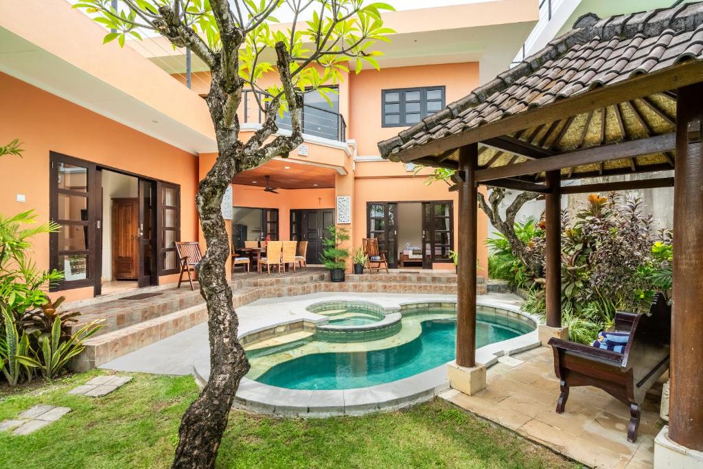 an image of a villa with a swimming pool at Nipper Resort & Villa Nusa Dua in Ujung