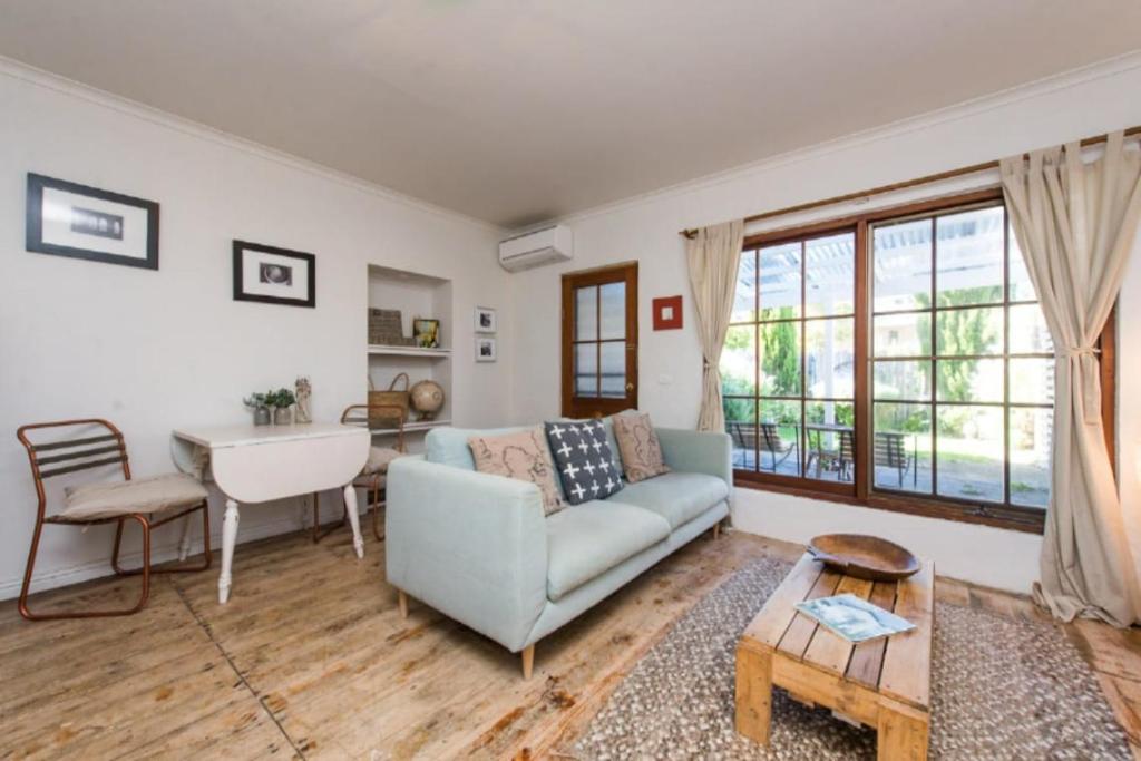 a living room with a couch and a table at Duilius in Robe
