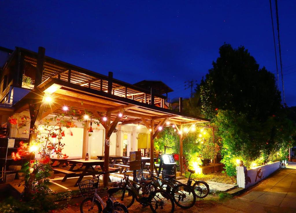 a group of bikes parked under a pavilion at night at ゲストハウス303 in Zamami