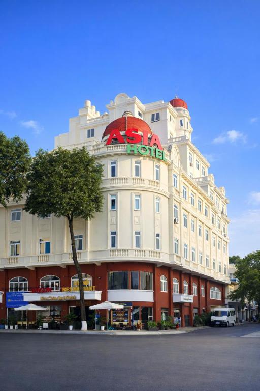 a large white building with a sign on it at Khách Sạn Á Châu Cần Thơ in Can Tho