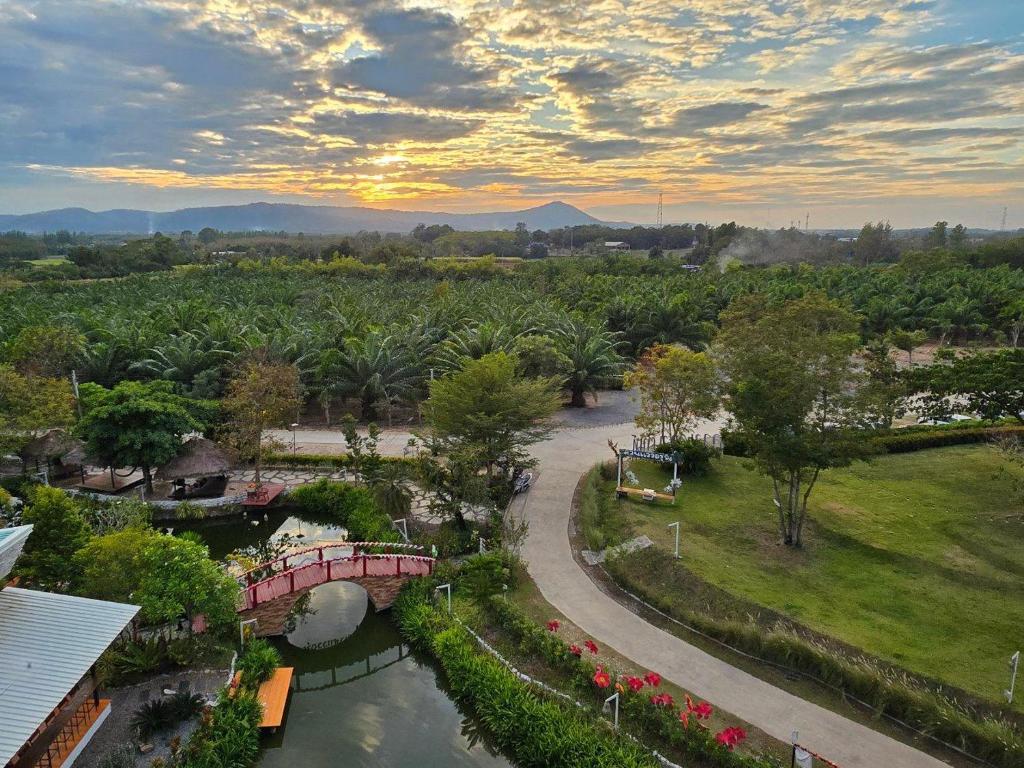 an aerial view of a park with a bridge and a river at Waew Arun Garden Resort in Ban Na Chik