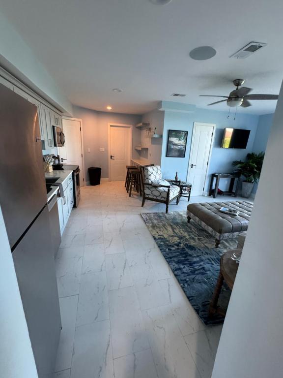 a kitchen and a living room with a couch and a table at Buck island Breeze in Christiansted