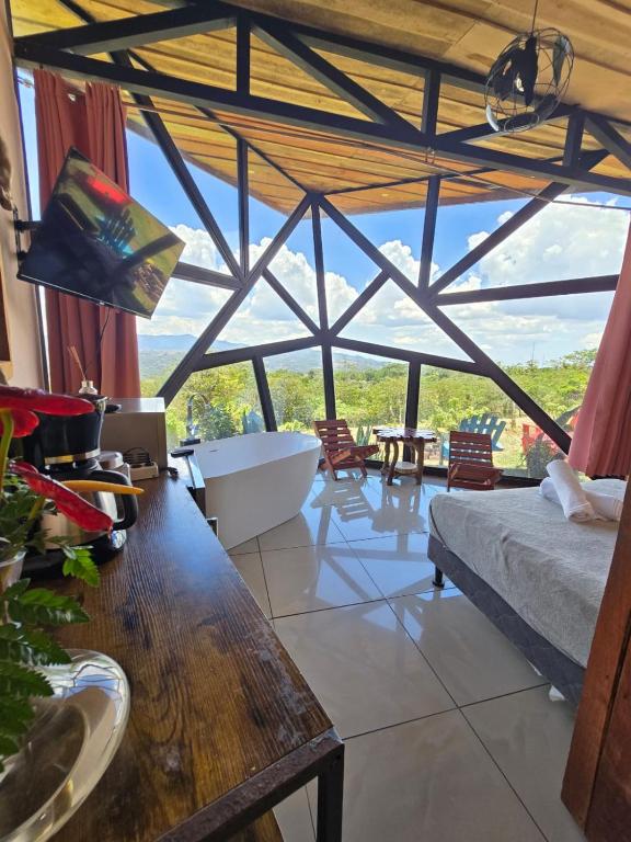 a living room with a large glass ceiling at Jannah Cabaña romántica con jacuzzi in Ángeles