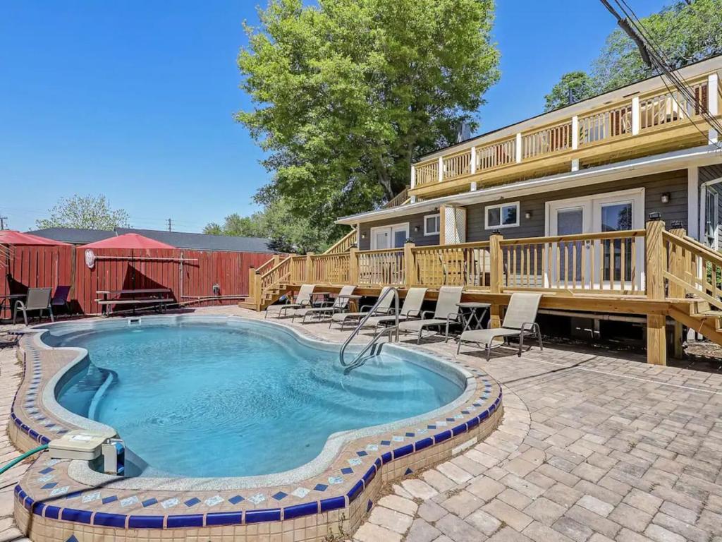 a house with a swimming pool and a deck at Historic Savannah Condo, Sleeps 6, Pool, Dogs Ok in Savannah