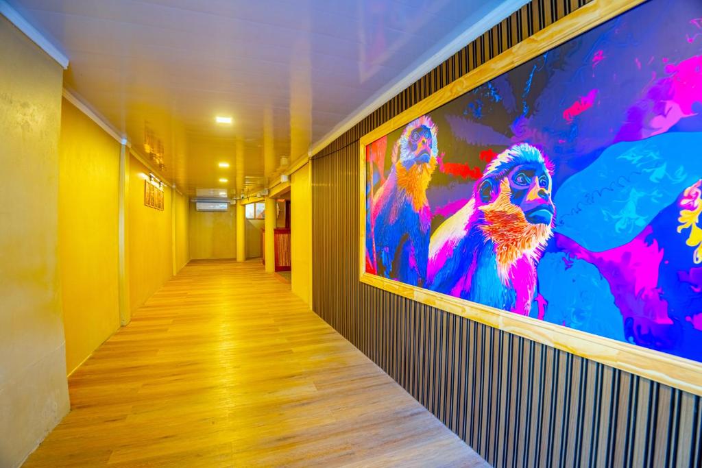 a hallway with a large painting on the wall at The Social Fortuna in Fortuna
