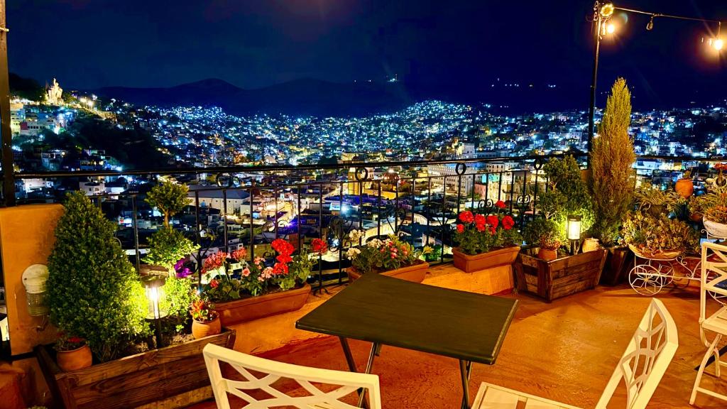 a balcony with a view of a city at night at Casa Rofo in Guanajuato