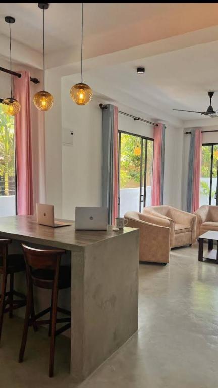two laptops sitting on a table in a living room at The Ondoro in Kamburugamuwa