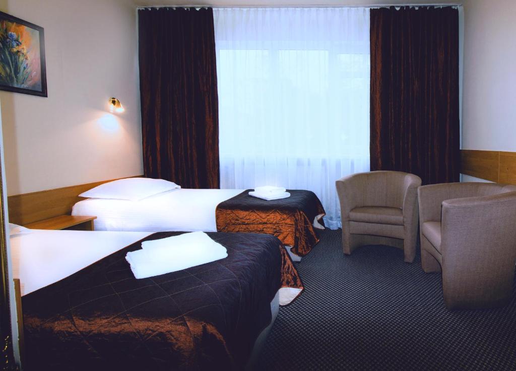 Posteľ alebo postele v izbe v ubytovaní HotelsLublin