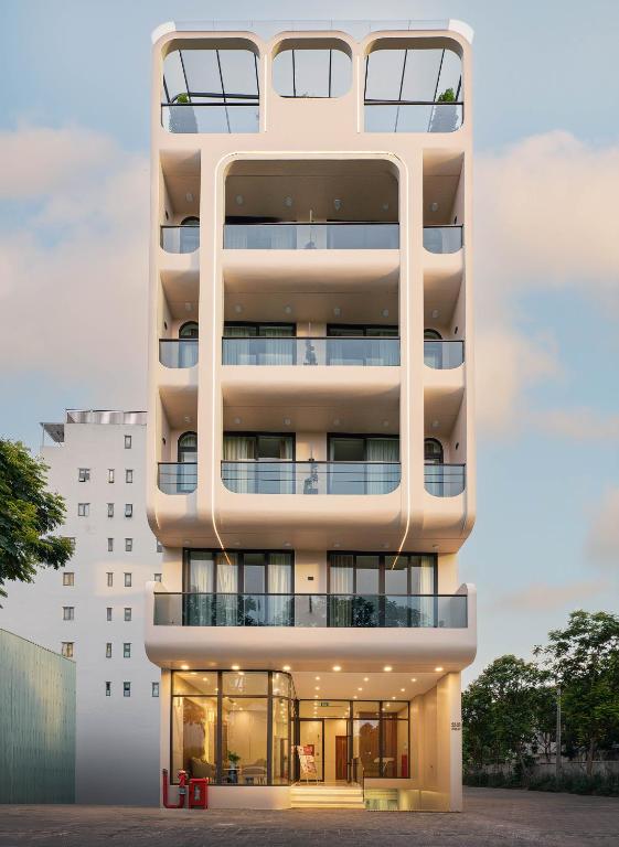 an apartment building with a white facade at BRIO Ventura Apartment in Danang