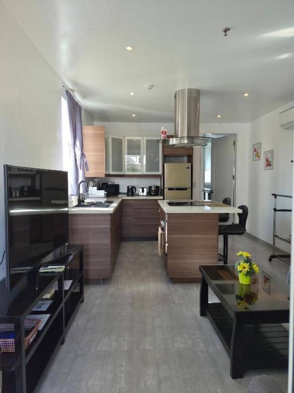 a large kitchen with wooden cabinets and a stove at Scandi Villas Boracay by Simple Realty Management in Boracay
