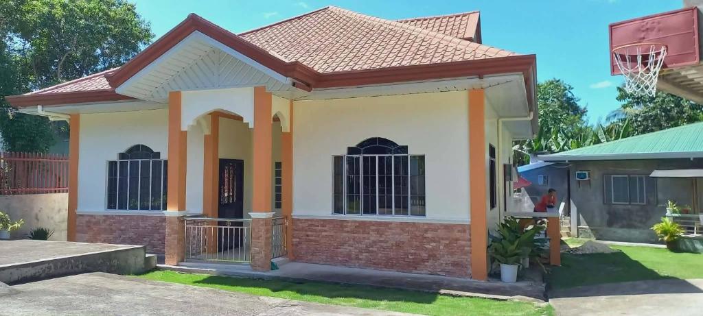 a house with a basketball hoop in the yard at Spacious Villa in Baclayon