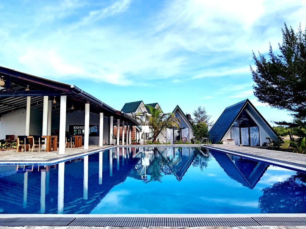 a villa with a swimming pool in a resort at Pini Villa in Ampara
