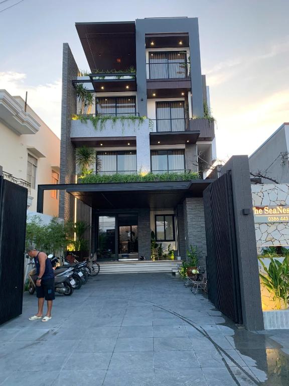 a man standing in front of a building at The SeaNest Home - Làng Chài Mỹ Tân Ninh Thuận in Vinh Hai