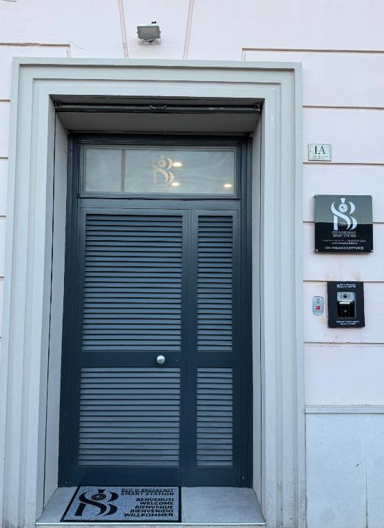 a door to a building with a dollar sign on it at B&B Smart Station Caserta in Caserta