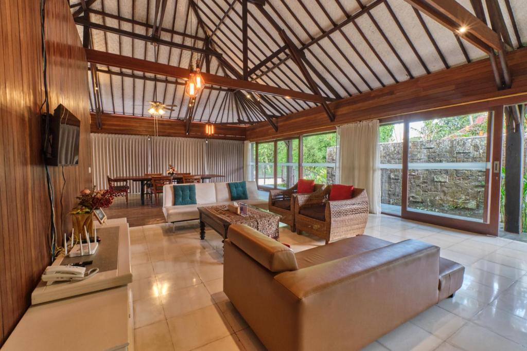 a large living room with couches and a table at Miko Villas Ubud in Ubud