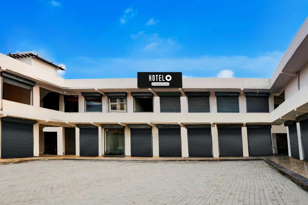 a large white building with a sign on it at Super Hotel O Greater Noida West Link Road Formerly Advent in Noida