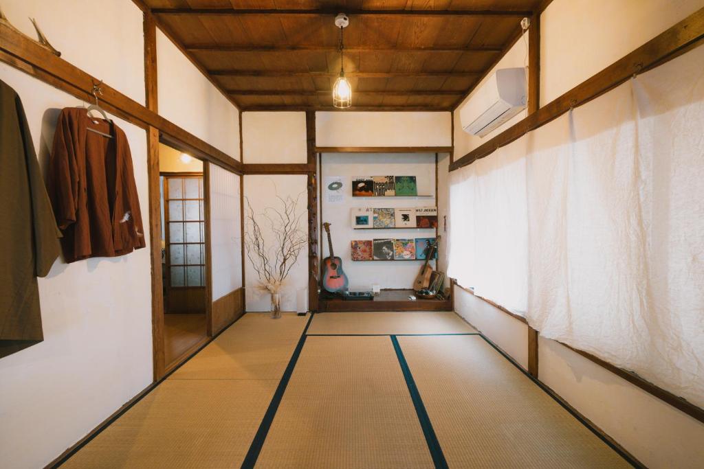 a hallway of a house with a room with a door at Kominka Hakone Entire Traditional House in Hakone