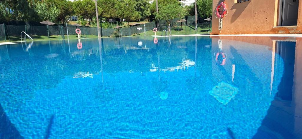 an empty swimming pool with blue water at A & G Sabinillas in San Luis de Sabinillas
