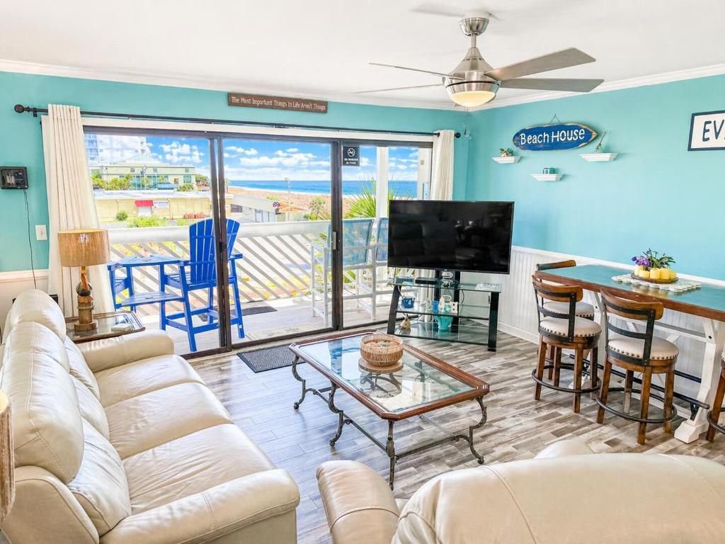 a living room with a couch and a flat screen tv at Ocean Shores 301 in North Myrtle Beach