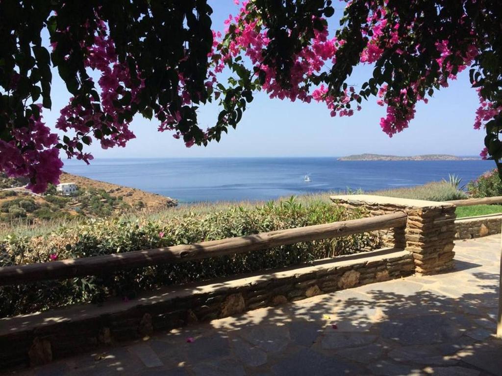a fence with a view of the ocean at Vila Cleopatra Andros Greece in Andros