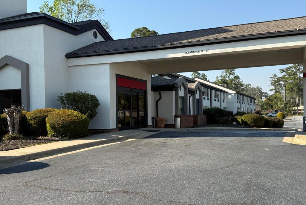 an empty parking lot in front of a building at Ramada by Wyndham Albany GA in Albany