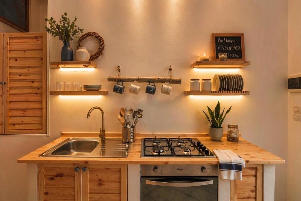 a kitchen with a sink and a stove top oven at Poésia in San Foca